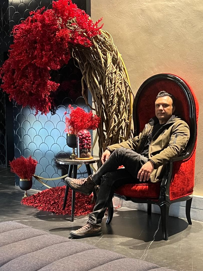 Alireza Vataniman seated in a red and black interior